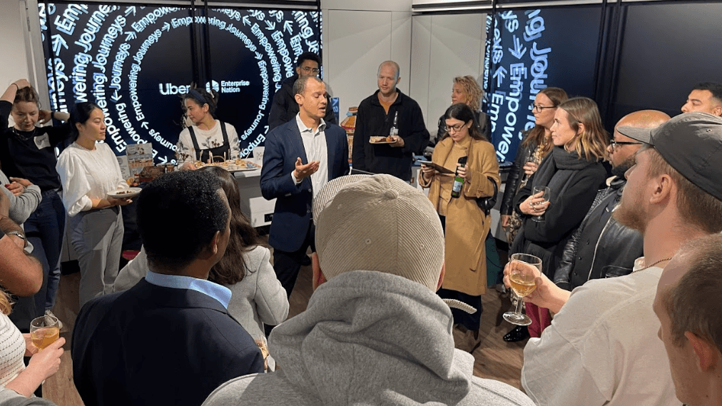 Group of people listening to a speaker at an evening event in Sook Oxford Street for Uber