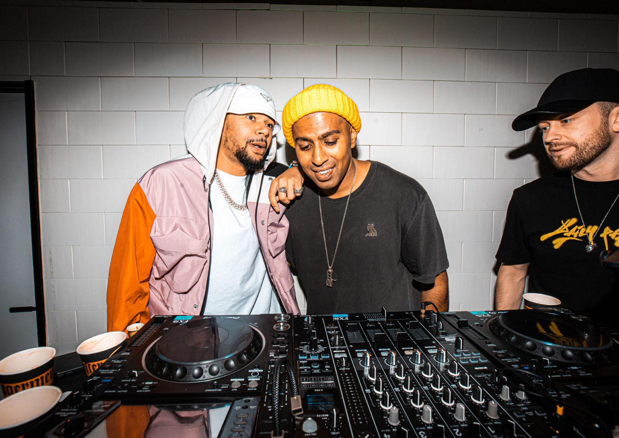 Three men behind DJ decks at Sook Oxford Street in basement during Jagermeister pop up
